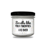 a jar of white candles with a black lid
