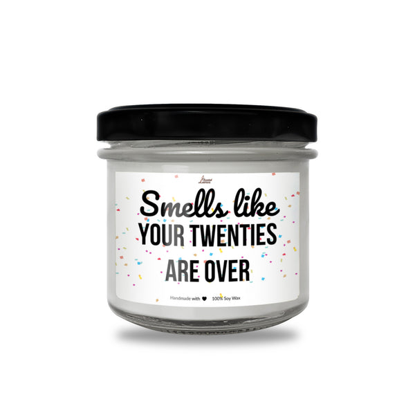 a jar of white candles with a black lid