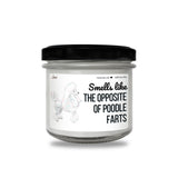 a jar of white candles with a black lid