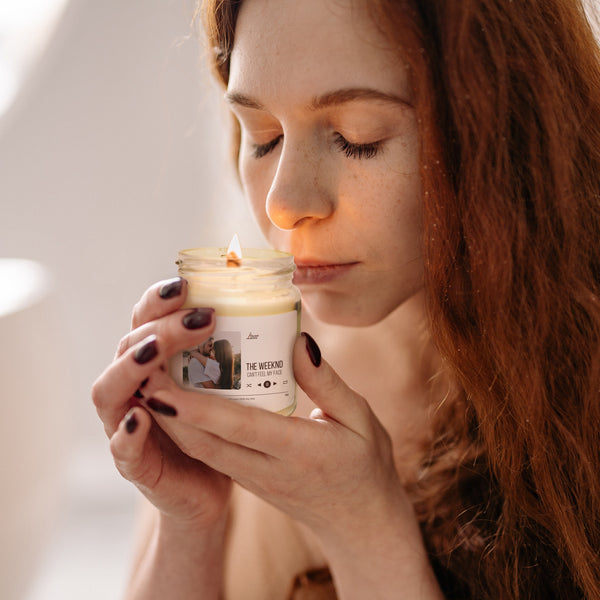 a woman holding a jar of cream in her hands