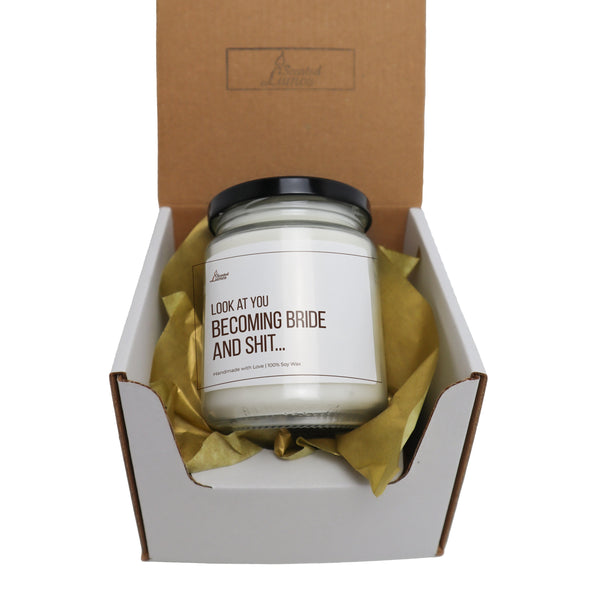 a white candle sitting inside of a box