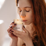 a woman holding a jar of whipped cream