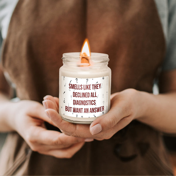 a woman holding a candle with a quote on it