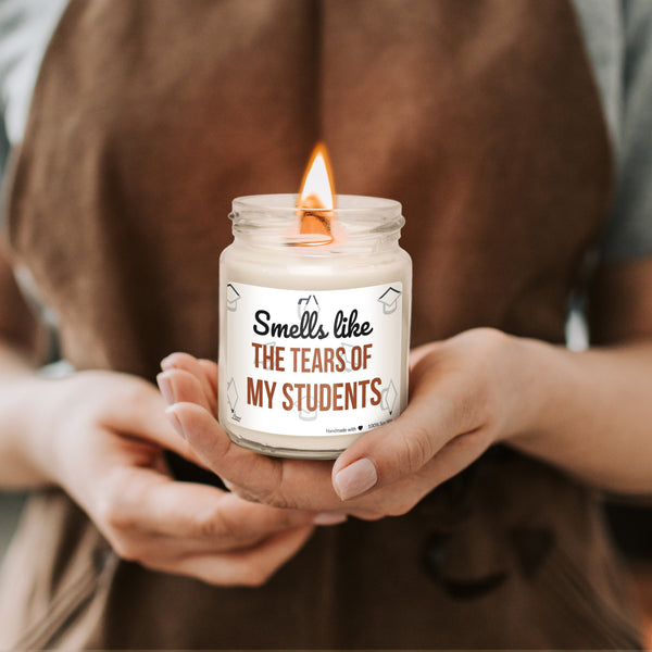a woman holding a jar with a candle in it