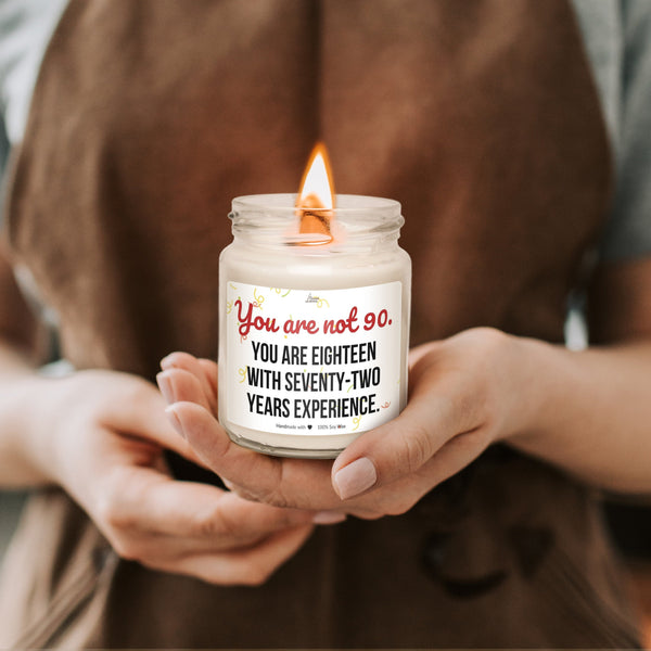 a woman holding a candle with a message on it
