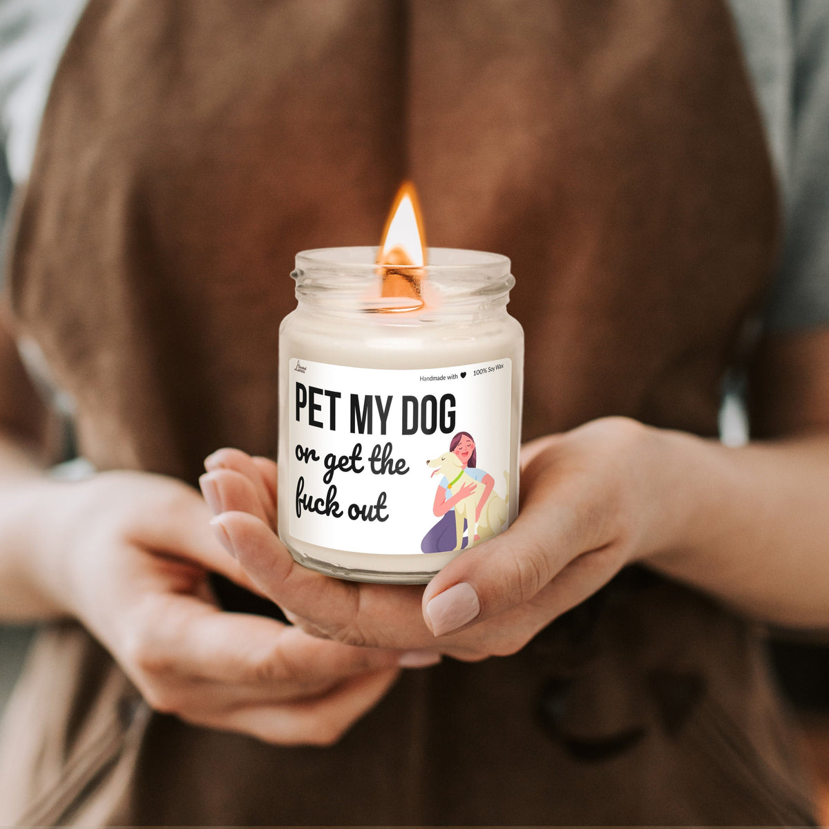 a person holding a candle with a sticker on it