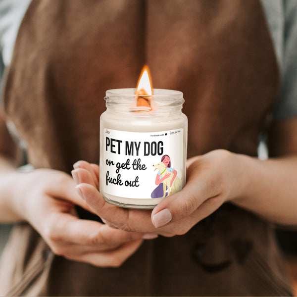 a person holding a candle with a sticker on it