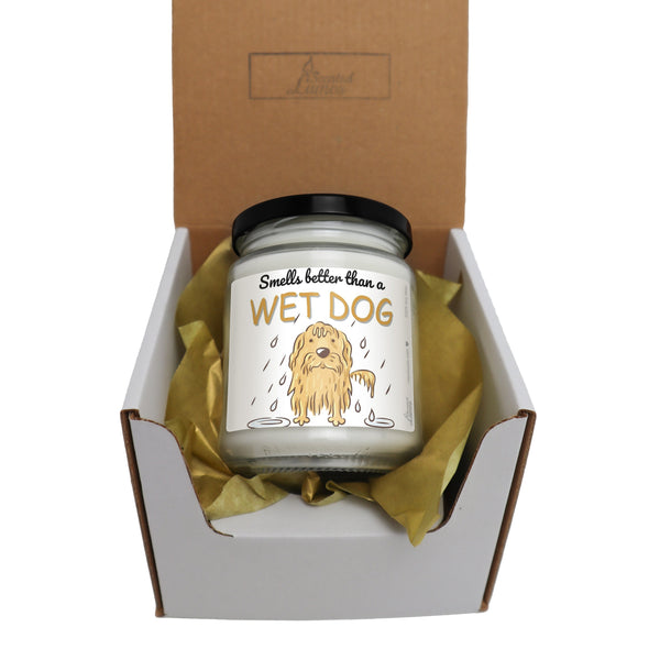 a dog candle in a box with a ribbon around it