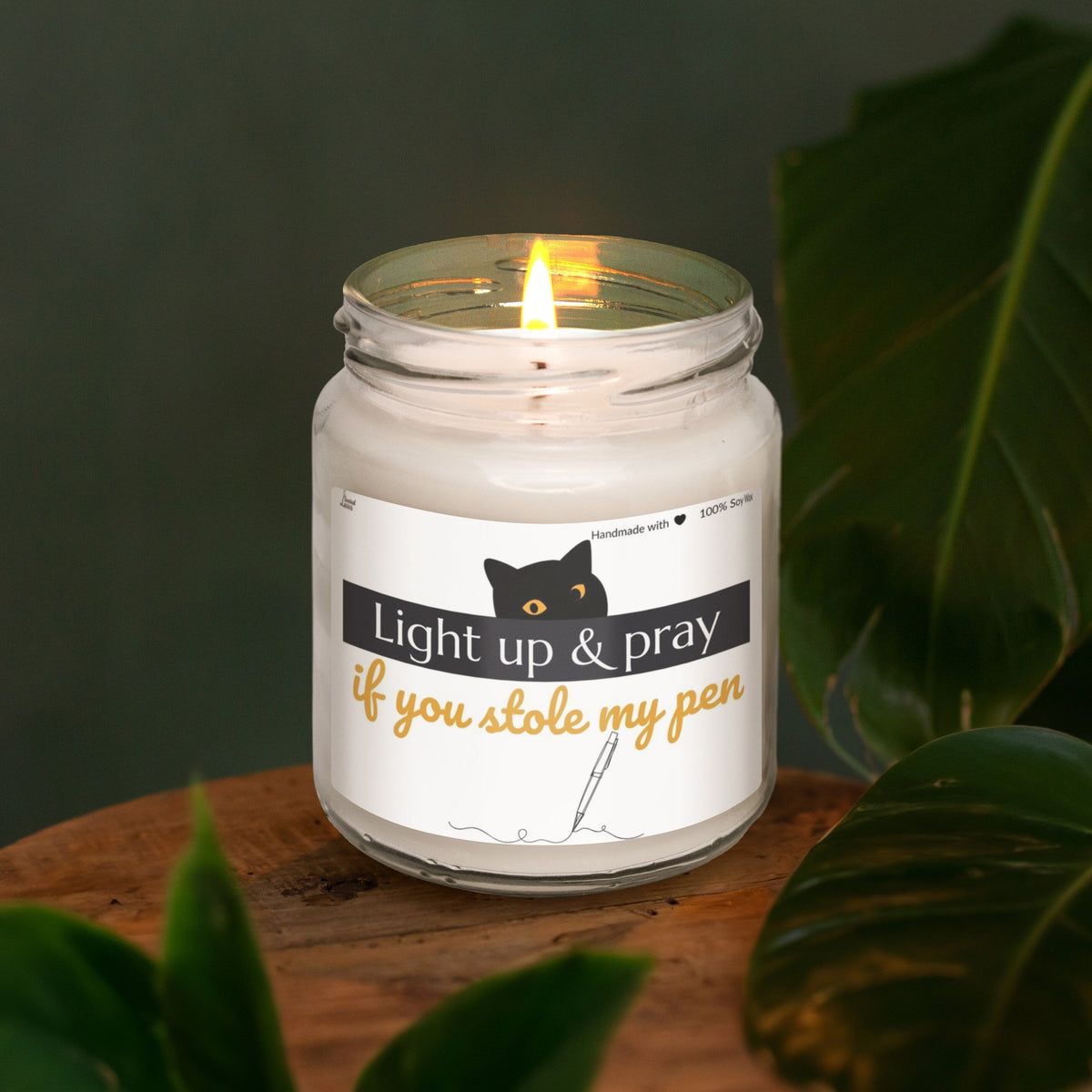 a lit candle sitting on top of a wooden table