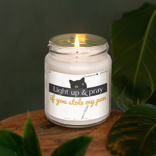 a lit candle sitting on top of a wooden table
