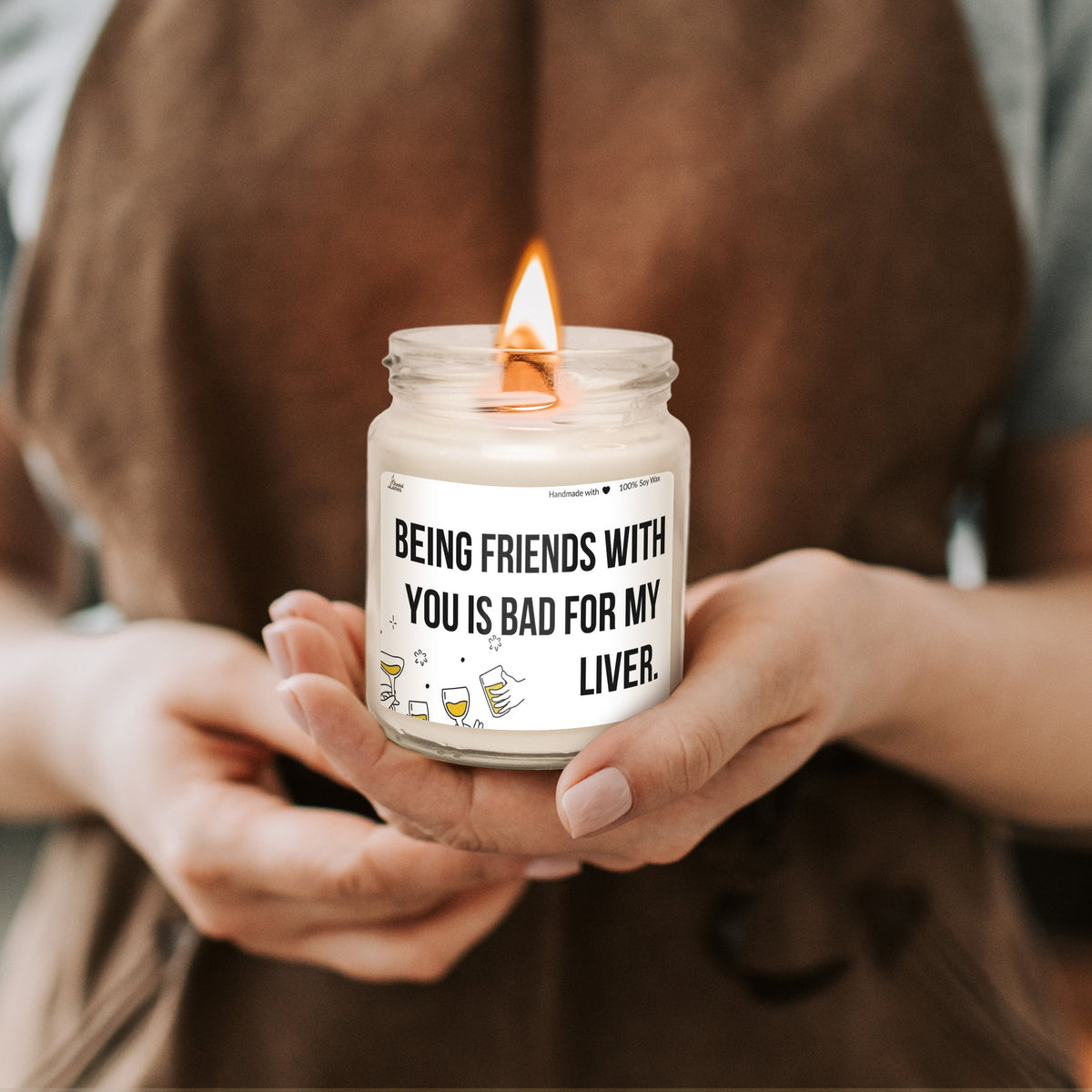 a person holding a candle with a message on it