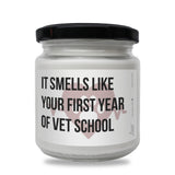 a white jar with a black lid that says it smells like your first year of