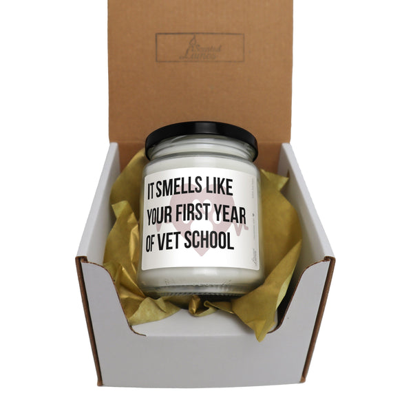 a candle in a box that says it smells like your first year of vet school