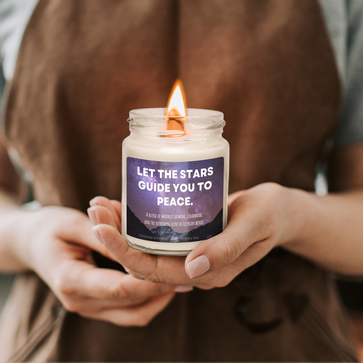 a person holding a candle that says let the stars guide you to peace