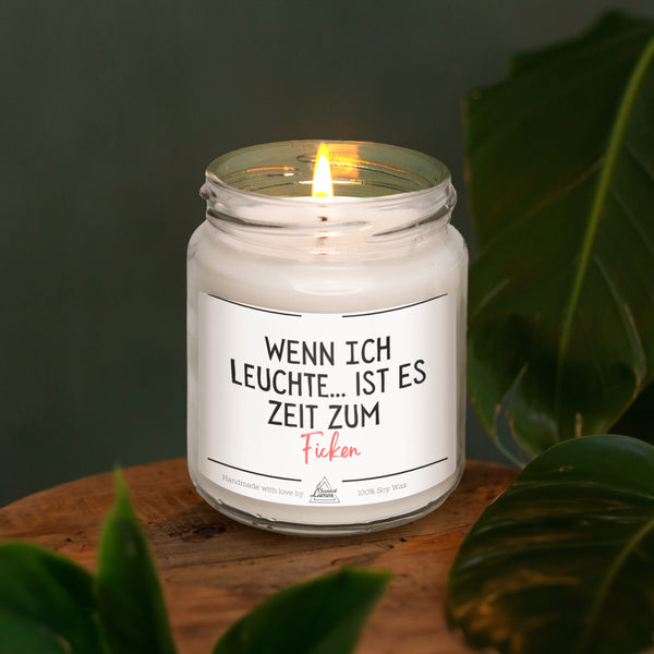 a lit candle sitting on top of a wooden table