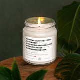 a white candle sitting on top of a wooden table