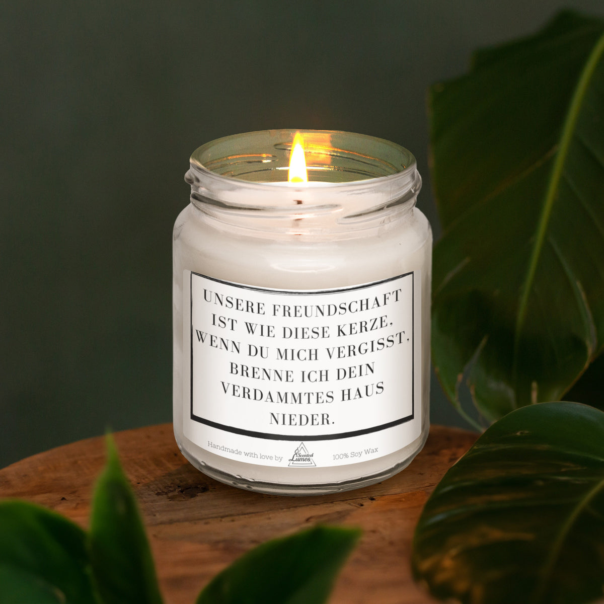 a white candle sitting on top of a wooden table