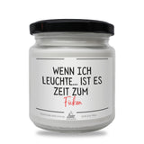 a white jar with a black lid on it