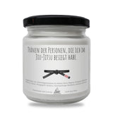 a jar of white wax with a black lid