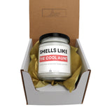 a candle in a box that says smells like the cool adult