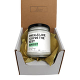 a jar of toothpaste sitting inside of a box