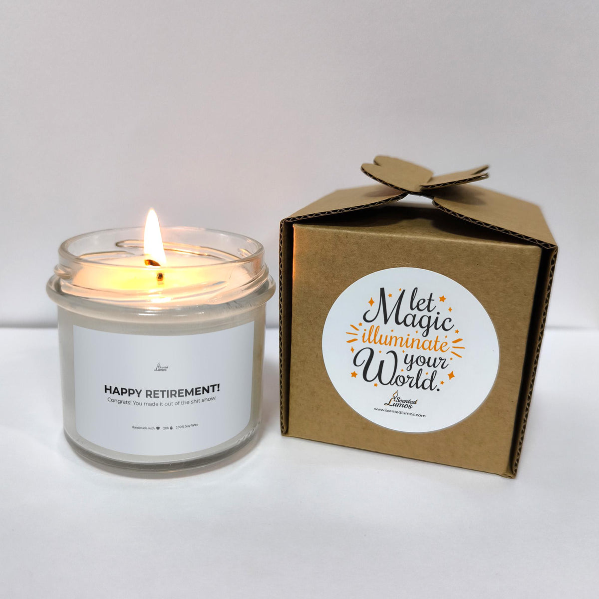 a white candle sitting next to a brown box