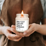 a person holding a candle with a message on it