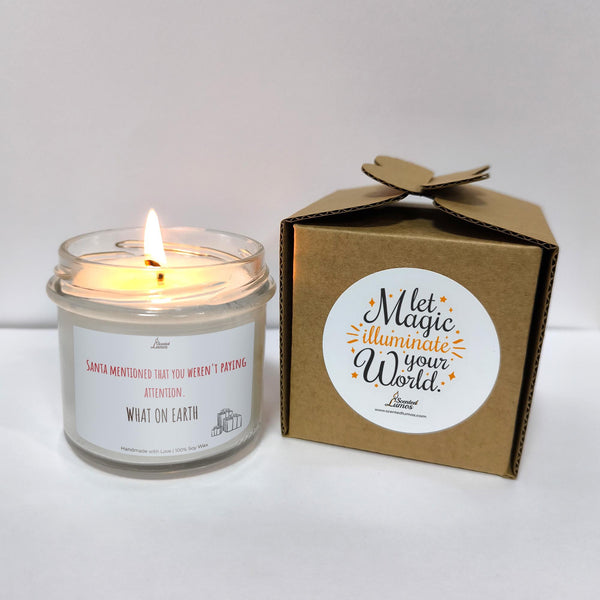 a white candle sitting next to a brown box