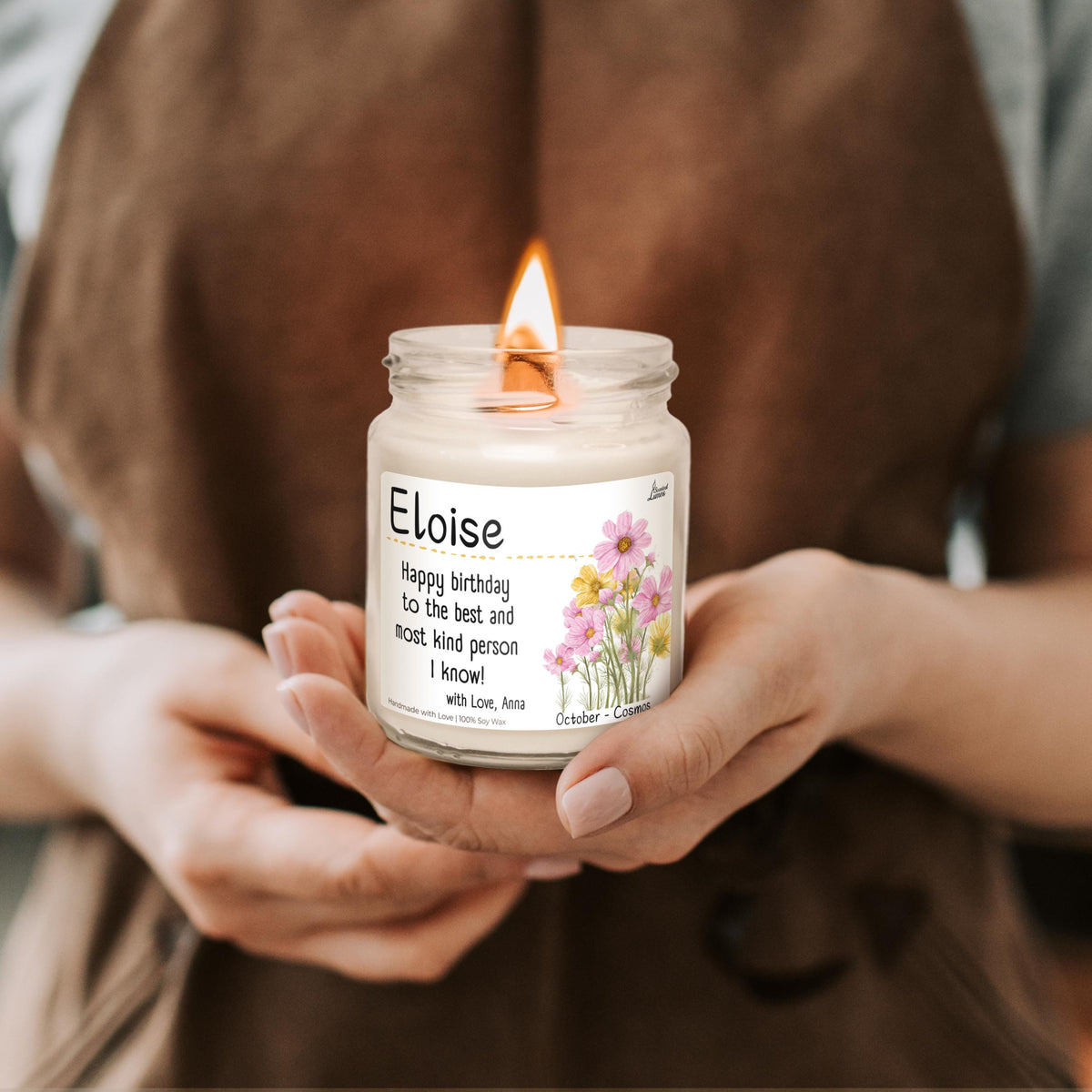 a woman holding a candle in her hands