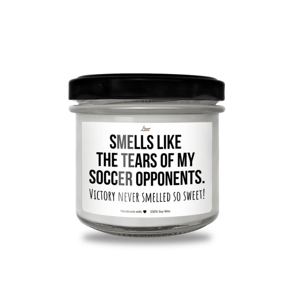 a white jar with a black lid that says smells like the tears of my soccer