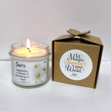 a candle sitting next to a cardboard box