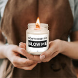 a woman holding a candle that says don't forget to blow me